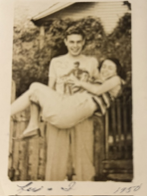 A young man holding a small child outdoors