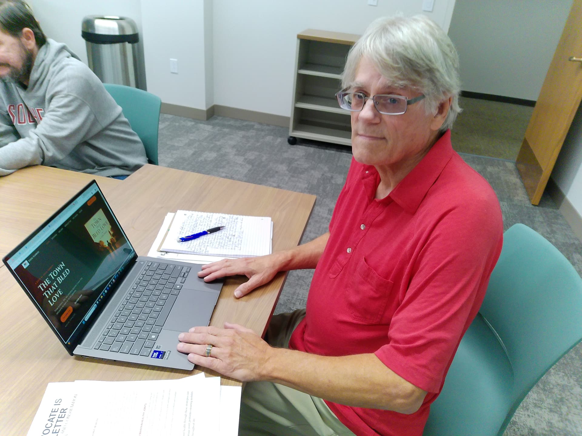 Eddie Harbert working on The Town That Bled Love at his laptop