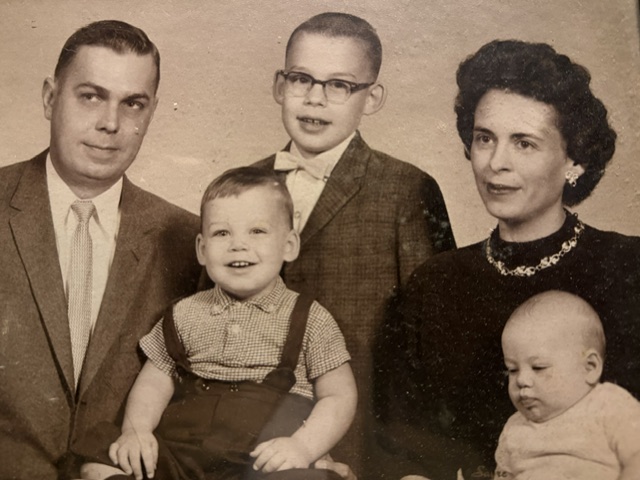 Sepia family portrait with two parents and four children