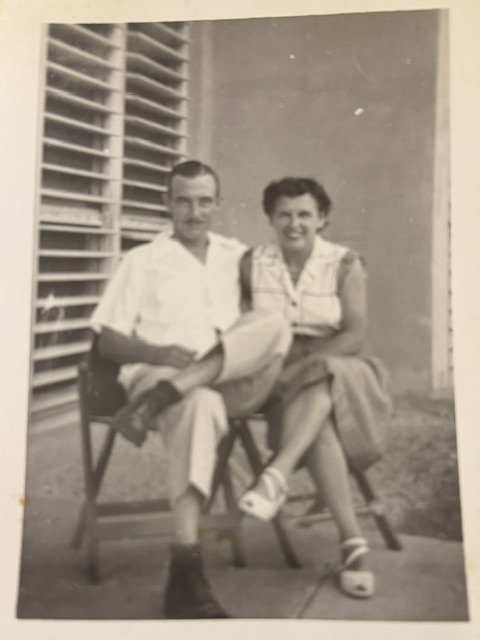 Black and white photograph of a couple seated on a porch