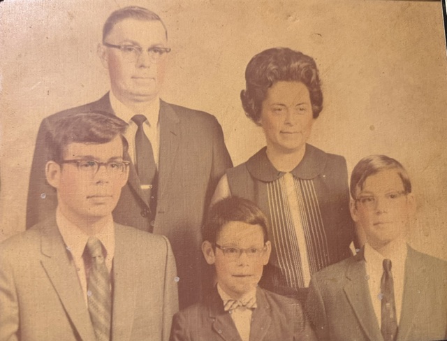 Family portrait of two parents and three boys in formal clothes